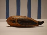 a small wooden fish on display on a table