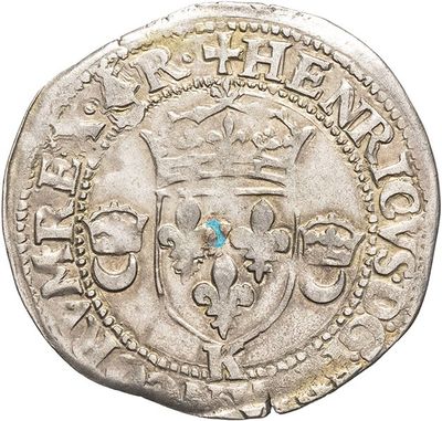 a silver coin with a crown on top of it