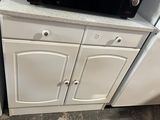 a microwave on top of a cabinet in a kitchen