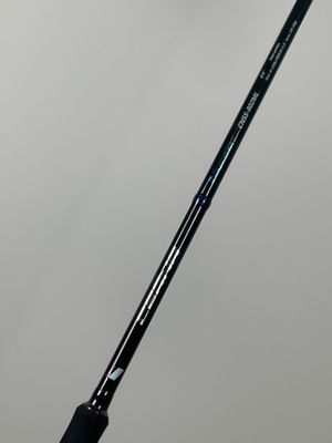 a close up of a black and white golf club on a white surface