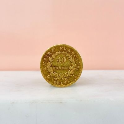 an image of a gold coin on a pink background