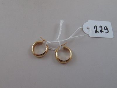 two pairs of gold hoop earrings with a price tag on a white background
