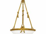 a gold and white glass hanging light fixture