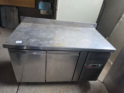 a stainless steel counter with two doors on it