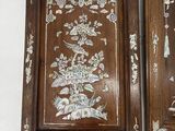 two wooden plaques with flowers and birds on them