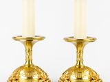 pair of antique brass candlesticks with lion heads on the bases