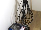 a vacuum that is sitting on the floor next to a wall