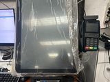 a computer monitor sitting on top of a desk covered in plastic