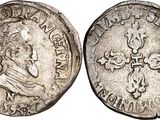 a silver coin with a cross on the front and a cross on the back