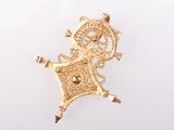 an image of a gold plated brooch with a woman on it