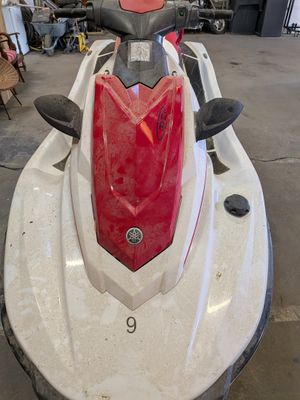 a picture of a white and red jet ski in a garage