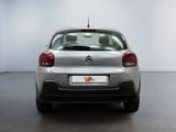 the rear of a silver citrole parked in a white room
