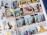 an open book with a comic strip and a comic strip on it