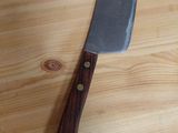a knife that is on a table with a wooden handle