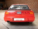 an image of a red car parked in a garage