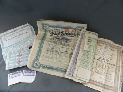 Plusieurs anciens certificats sont empilés les uns sur les autres sur une table