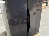 two refrigerators sitting on a pallet in a warehouse