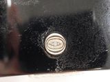 a close up of a black and silver object on a table