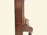 a wooden piano that is sitting on a stand