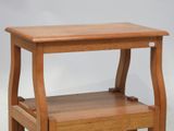 a small wooden step stool with a shelf on it
