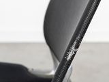 a close up of a black chair with a zipper on it