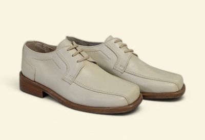 men ' s white leather shoes on a white background