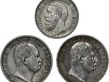 trois pièces d'argent sur lesquelles figurent un homme et une femme