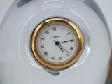a white vase with a gold rim and a clock on it