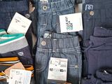 many different types of jeans on display in a store