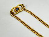 a gold chain with a blue stone in the center