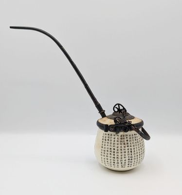 an image of a white vase with a black handle and a black handle