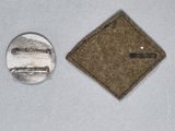 a small patch and a pin on a white surface