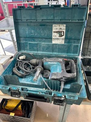 a blue tool box with a drill and other tools in it