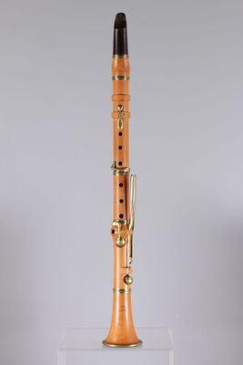 a wooden clarinet with a black top and gold hardware