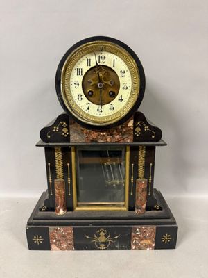 a black and gold clock on a marble stand