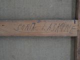 a close up of a wooden sign with writing on it