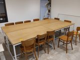 many chairs around a table in a room
