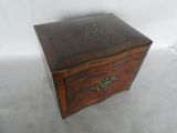 an old wooden box with a drawer on top of it