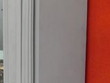 a tall white clock on display in a store