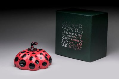a small red ladybug sitting next to a green box