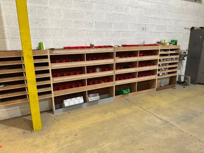 a room with a bunch of shelves and bins on the floor