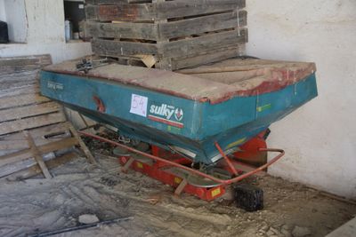 a blue cart with a pile of wooden pallets on it