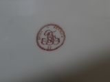a white plate with a red design on it