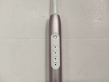 a close up of a toothbrush on a white surface