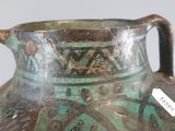 a green vase that is sitting on a table