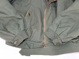 an image of a green jacket on a white surface with a white background