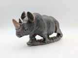 figurine of a rhino on a white background