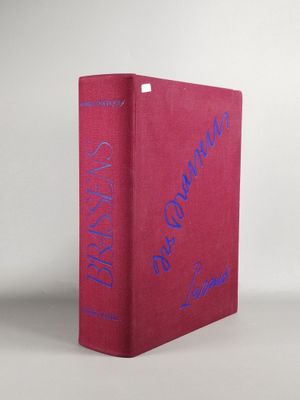 le livre est rouge avec des inscriptions bleues