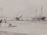 many boats that are sitting in the sand
