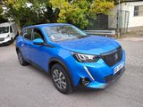 a blue car that is parked on the side of the road